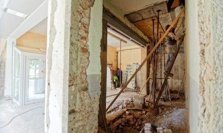 un homme grimpe sur une échelle à l'intérieur d'une pièce